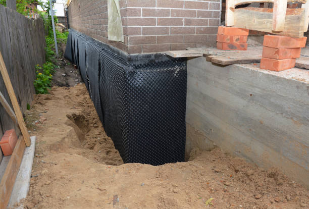 SJ Waterproofing Pros technician performing targeted Wet Basement Repair assessment in Dacula, GA